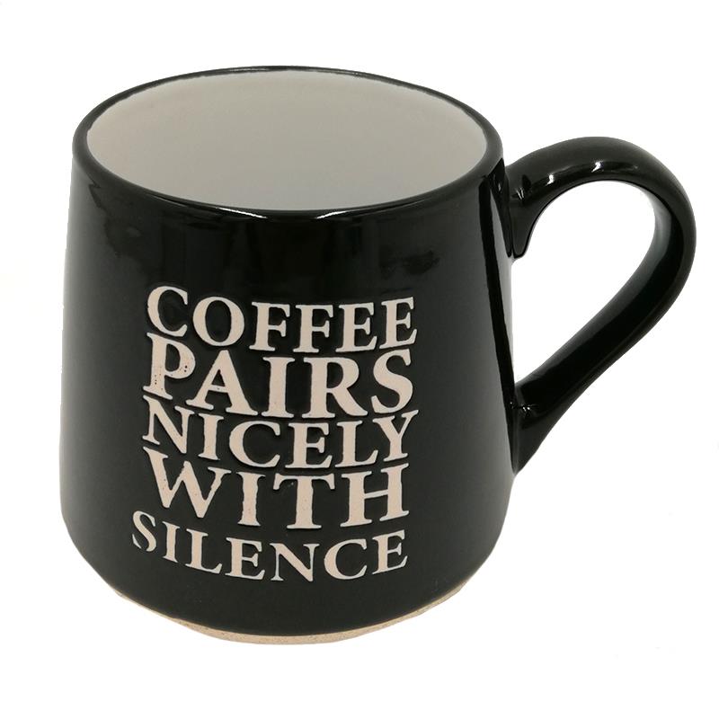 black coffee mug from Koppers with 'Coffee paris nicely with silence' on it, on a white background