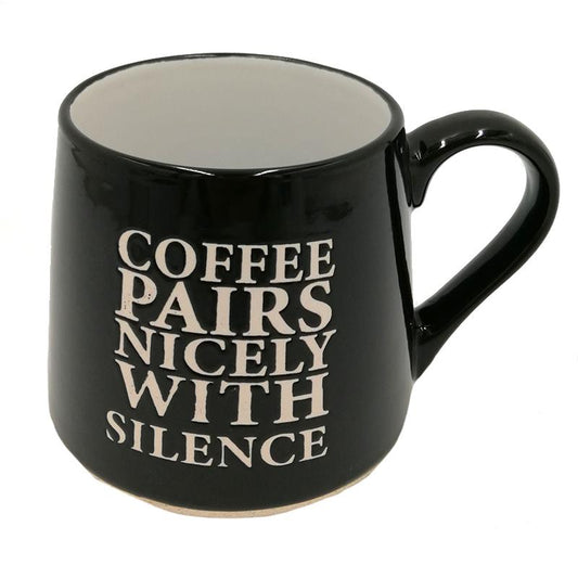 black coffee mug from Koppers with 'Coffee paris nicely with silence' on it, on a white background