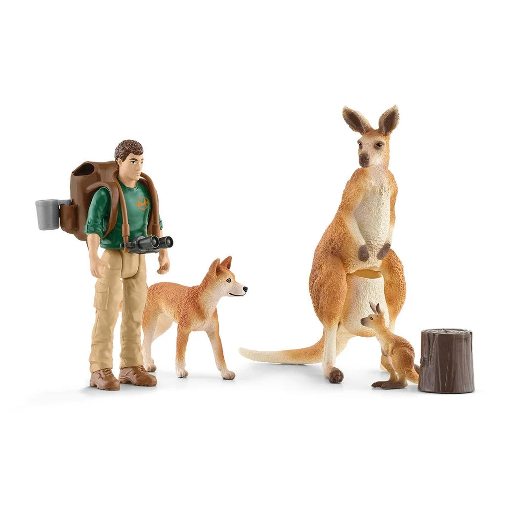 Set of firgurines with a kangaroo, and kangraoo baby, dog, man and out back adventure supplies from Schleich on a white background