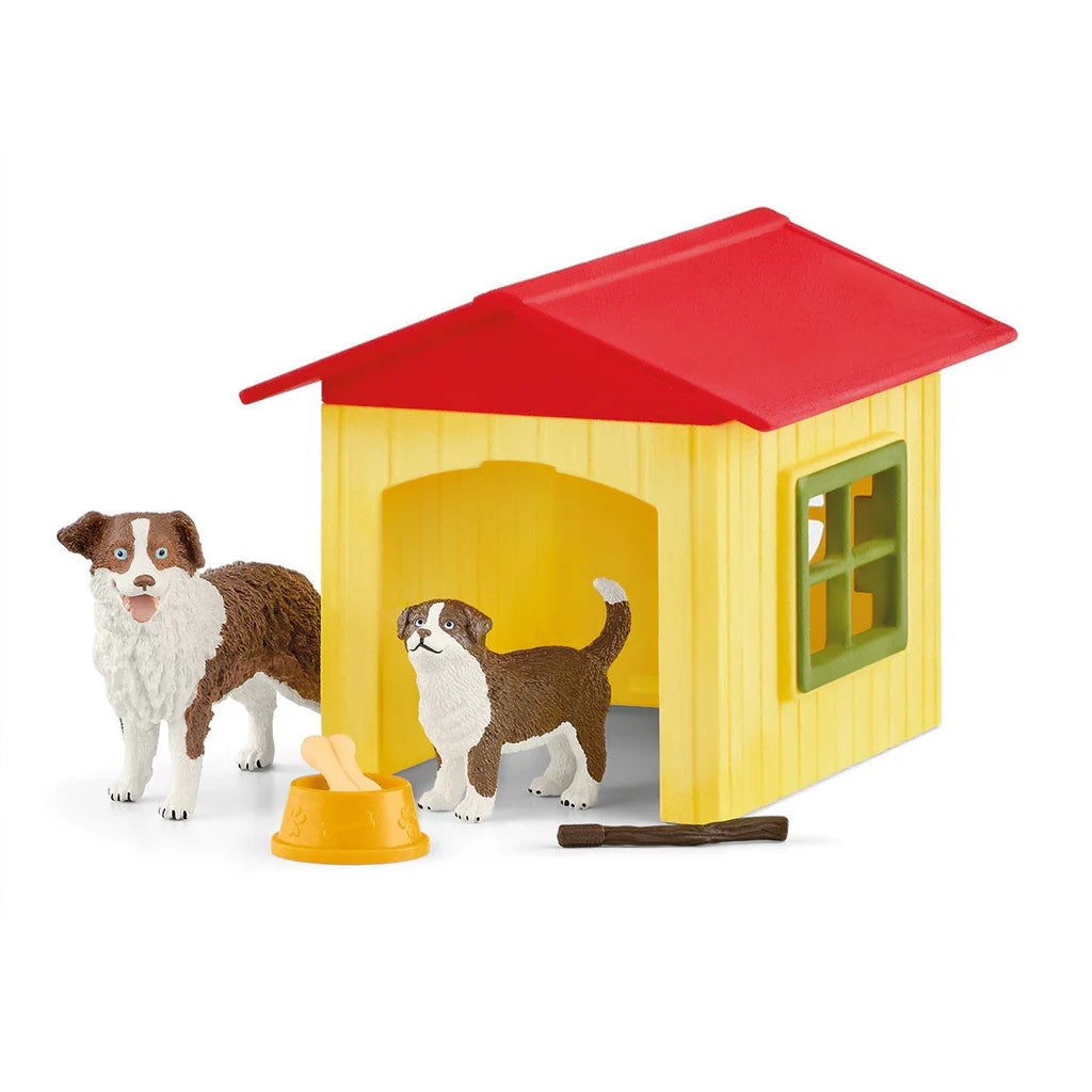 Toy doghouse with two toy dogs and a toy bowl on a white background by Schleich