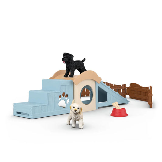 Schleich Pet play set with a small dog on a raised platform and another dog standing nearby on a white background.
