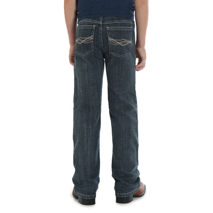 a boy wearing blue jeans and a navy t shirt on a white background