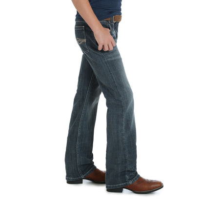 A pair of Wrangler Twenty X Vintage Boy's Jeans with a boot cut, featuring a slim seat and thigh design, with a zipper and snap closure.