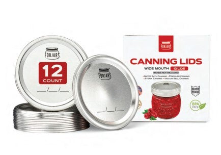 A pack of ForJars wide-mouth canning lids, showingtwo individual silver metal lids (one stacked on top of the other, the other standing upright with a red '12 COUNT' label), alongside their white retail packaging box.