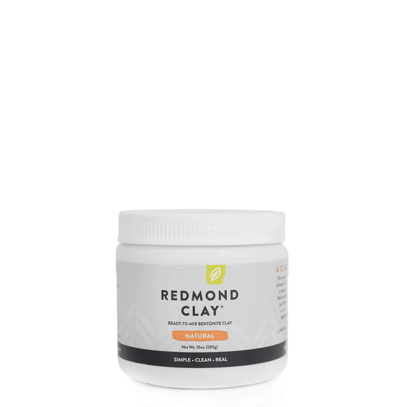 a white tub of redmond clay ready to mix bentonite clay on a white background