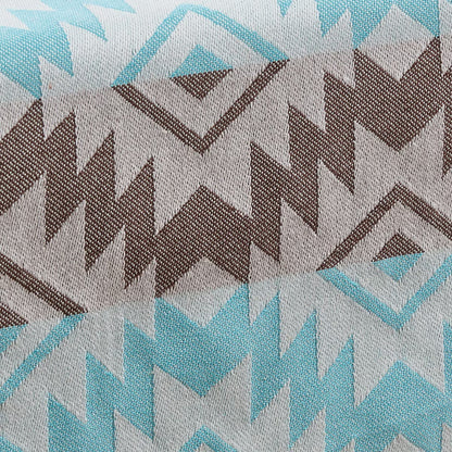 Close-up of fabric with geometric pattern in brown, blue, and gray.