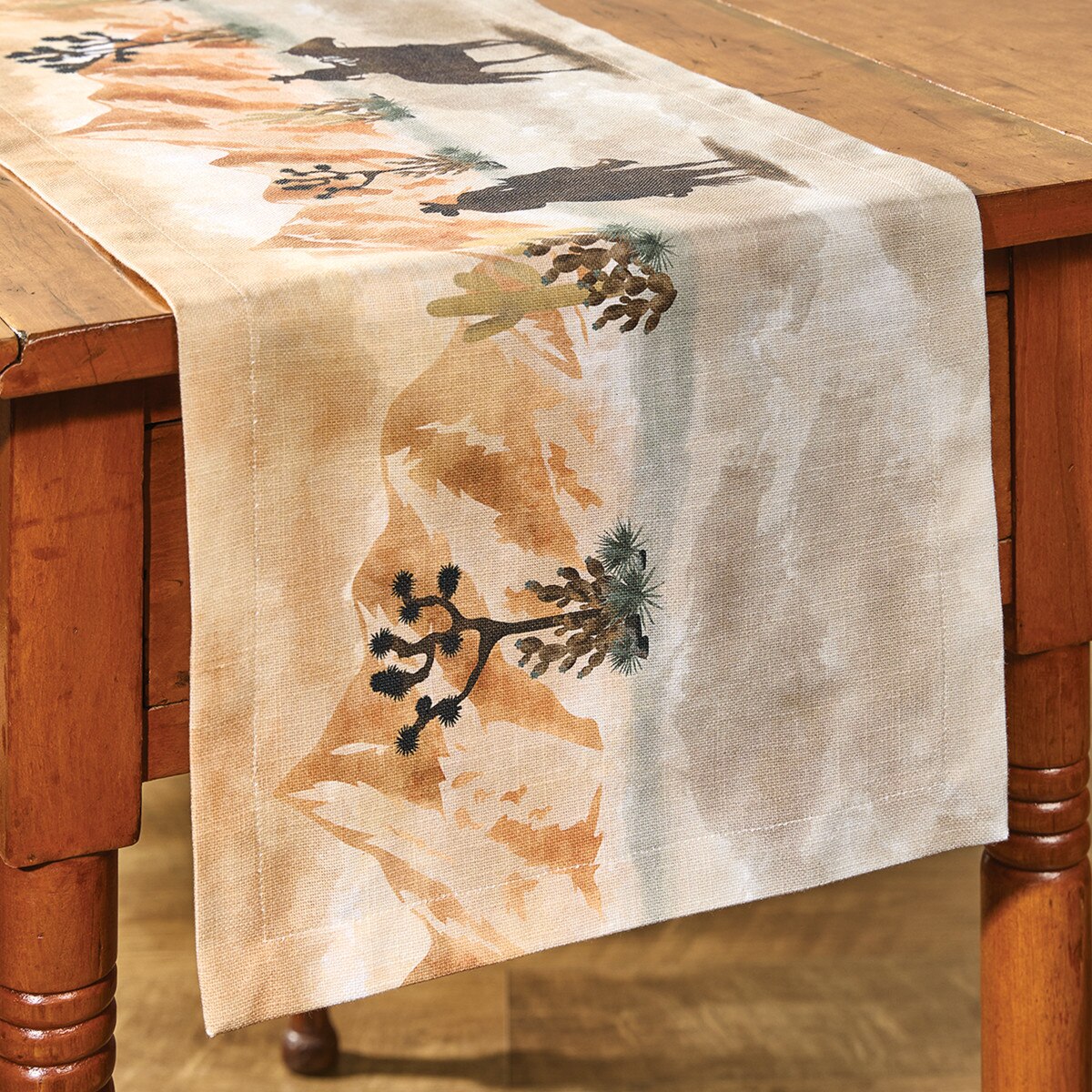 Table runner with desert-themed design on a wooden table
