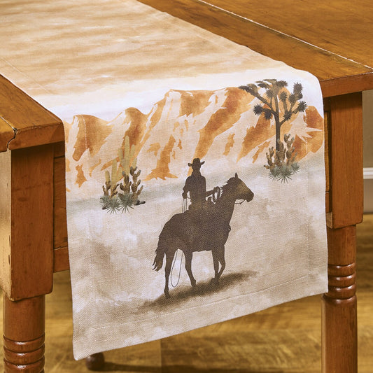 Table runner with a cowboy and horse design on a wooden table