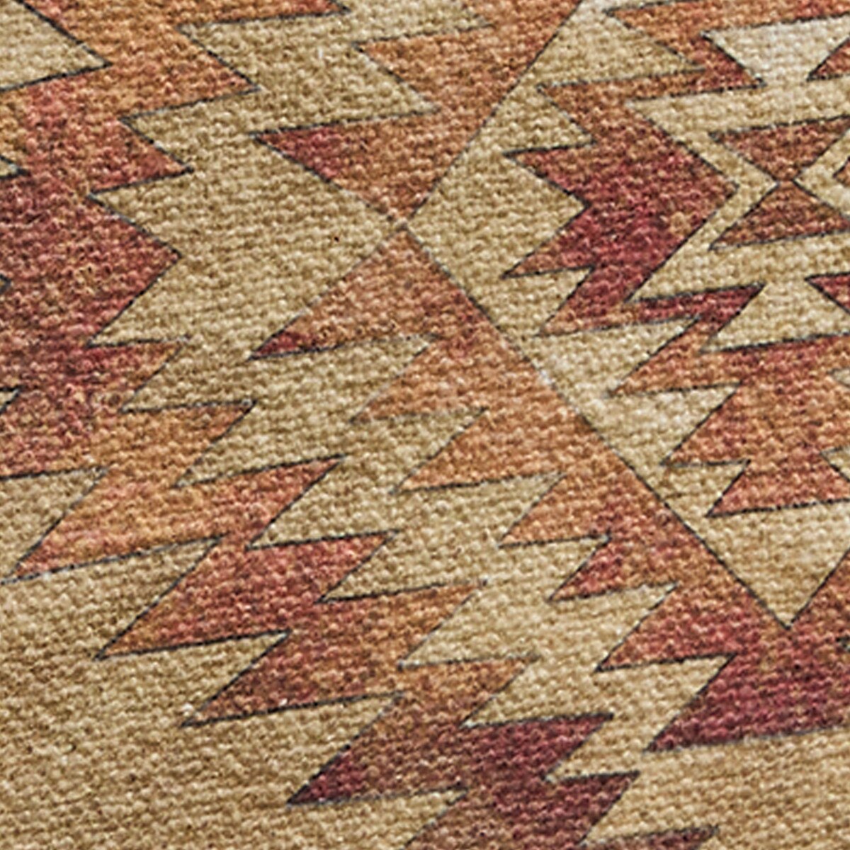 Close-up of a textured fabric with a geometric pattern in earthy tones.