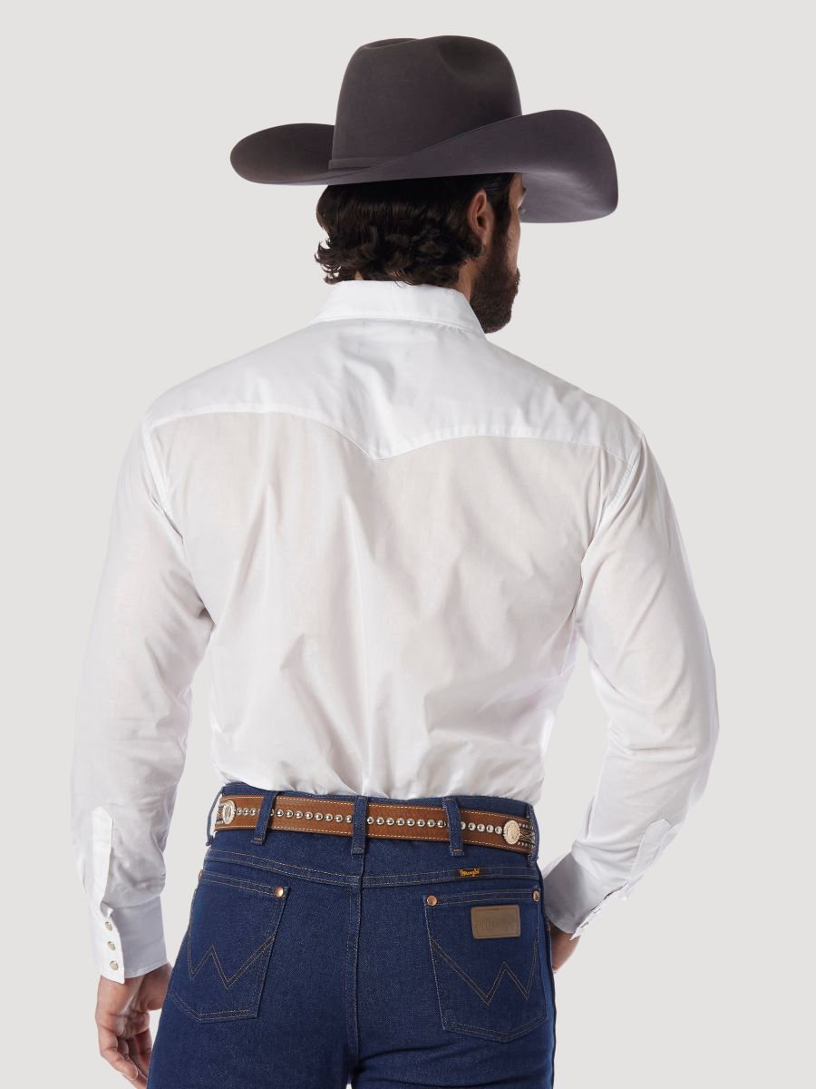 A man shown from behind wearing a white Wrangler western-style long-sleeve shirt, dark blue jeans, a brown studded belt, and a dark brown cowboy hat, against a light gray studio background.