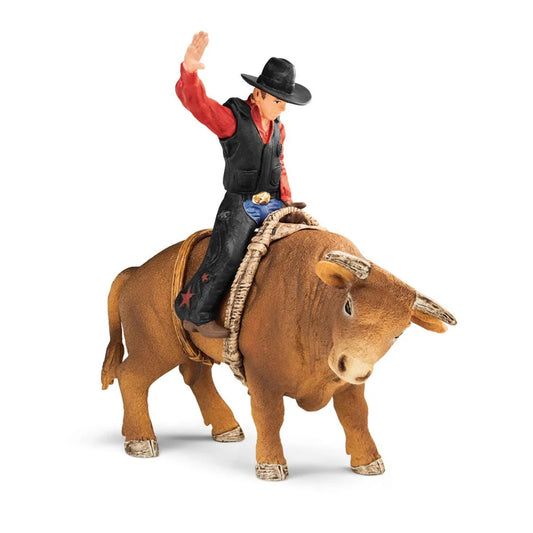 Schleich cowboy riding a bull figurine on a white background