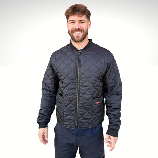 Man wearing a quilted black jacket on a white background