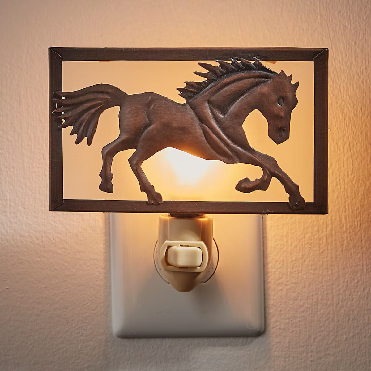 Decorative night light with a horse design on a beige wall.