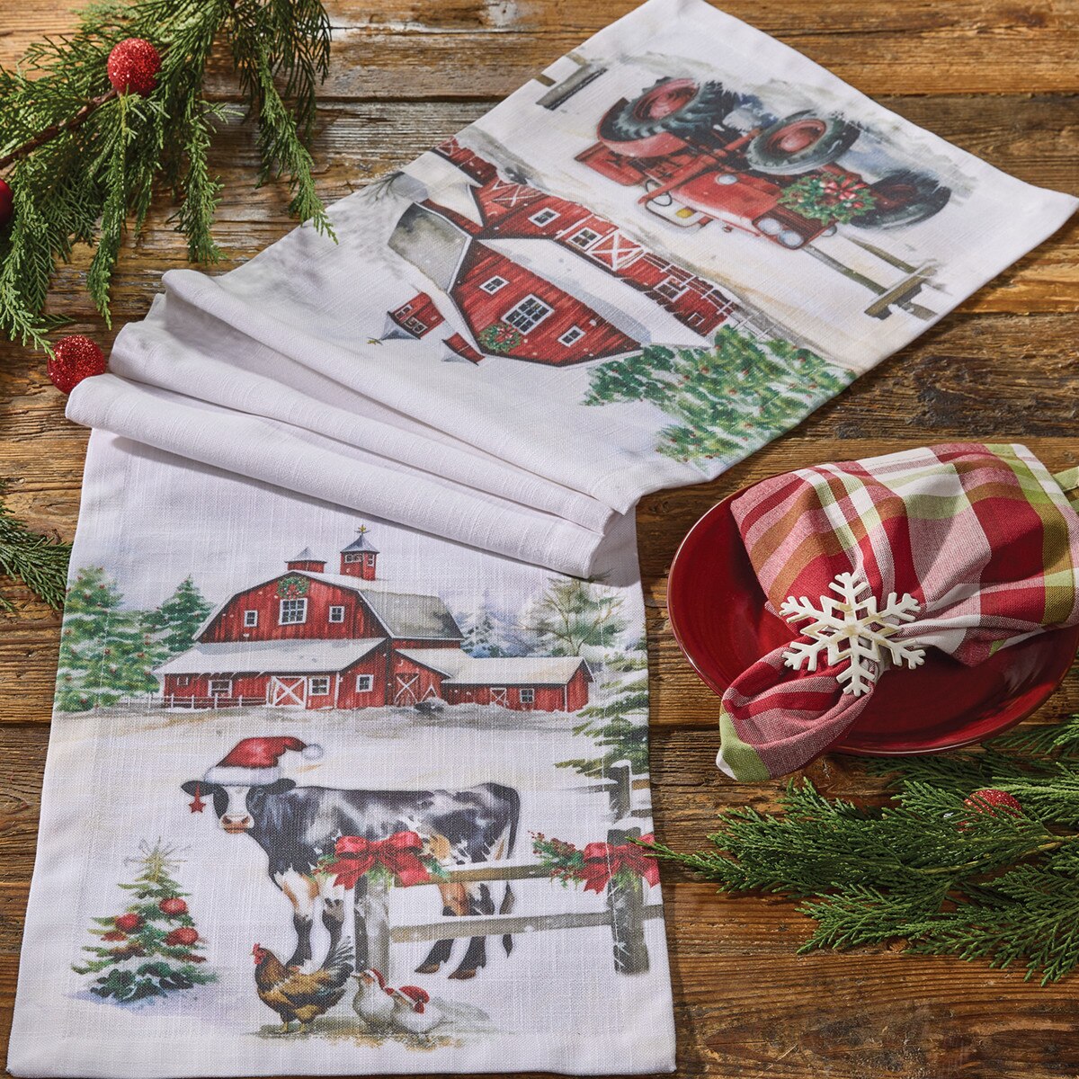 Christmas themed table runner from Park Designs with a farm scene including some animals, a barn and a tractor