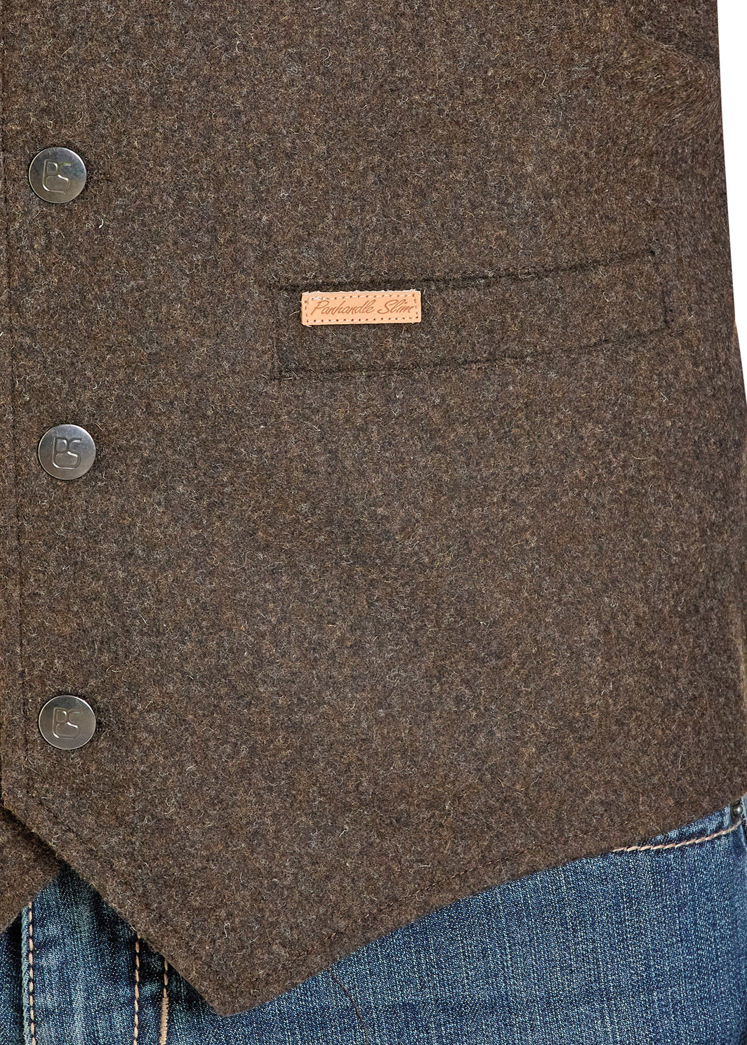 Close-up of a brown wool-blend vest from Panhandle Slim with a buttoned front, a welt pocket, and a small tan brand tab, worn over blue jeans.