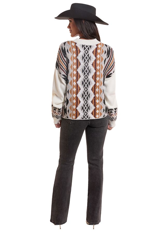 Woman wearing a natural colored Rock&Roll Denim cardigan, blue jeans and a black cowboy hat on a white background