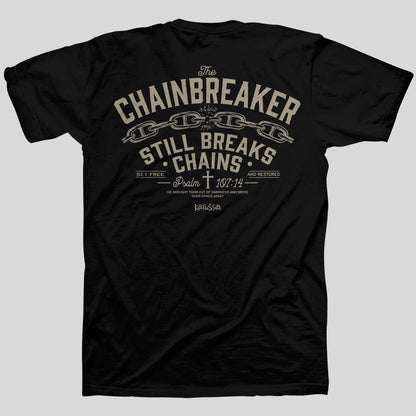 A black short-sleeve t-shirt from Kerusso shown from the back, featuring a distressed beige graphic print with the words 'The CHAINBREAKER STILL BREAKS CHAINS' and a chain motif, on a solid gray background.
