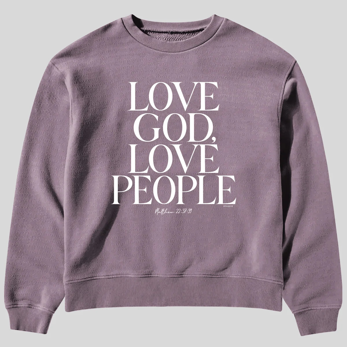A dusty purple crewneck sweatshirt from Kerusso featuring the text 'LOVE GOD, LOVE PEOPLE' in large white serif letters on the front, with a small Bible verse printed below.