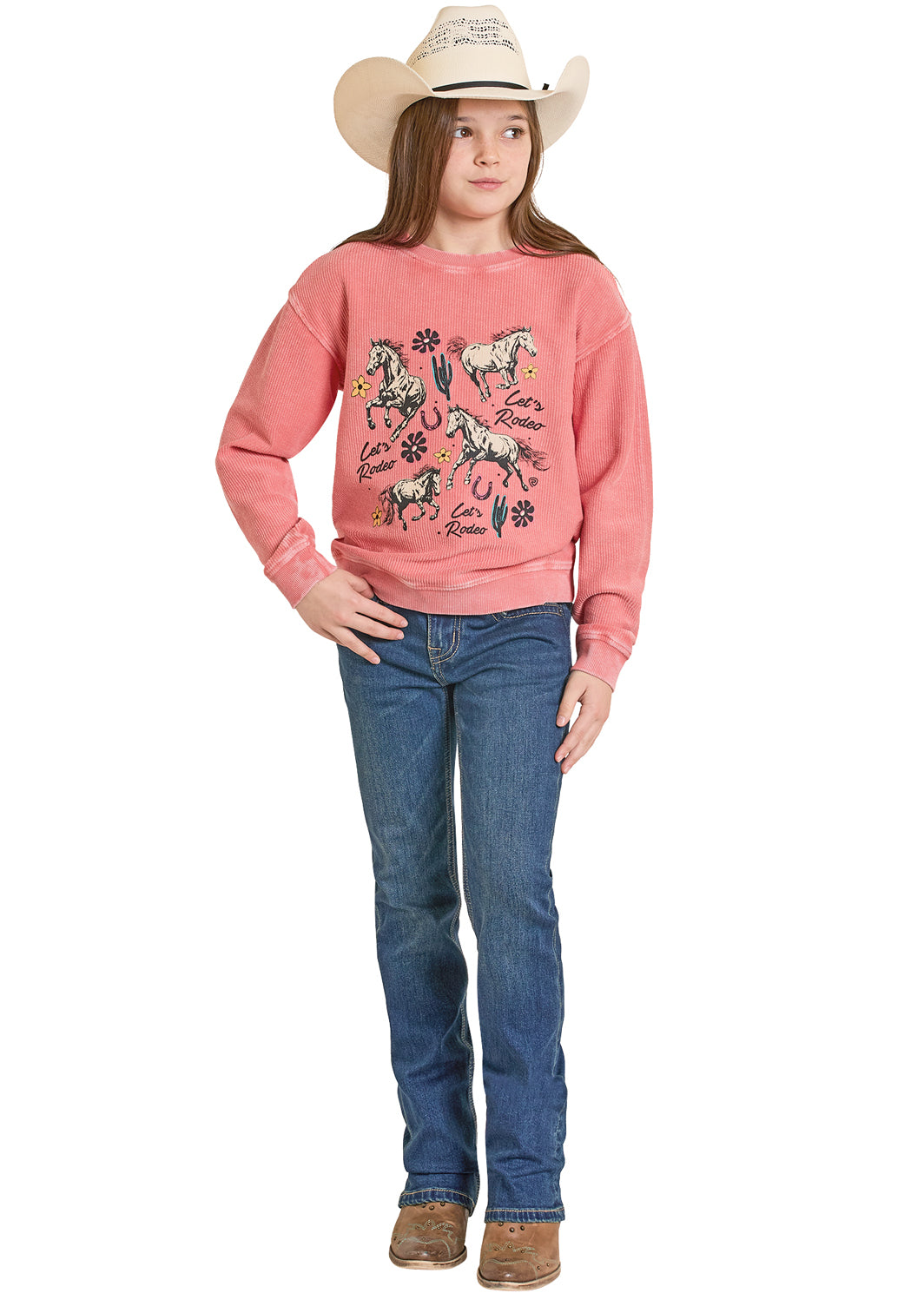 Girl wearing a pink sweatshirt with horse designs and blue jeans on a white background