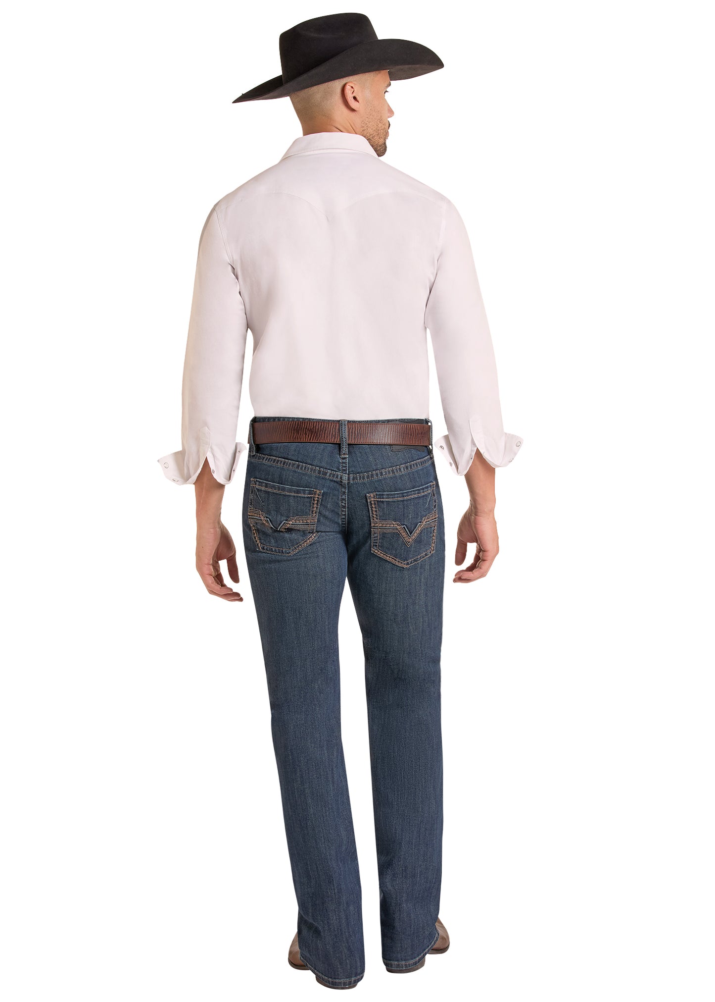 Rear view of a man wearing a white long-sleeve button-down shirt, dark blue jeans, a brown belt, and a black cowboy hat against a white background.