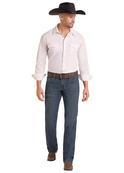 A man modeling a white western long-sleeve button-down shirt, blue jeans, a brown belt, and a black cowboy hat against a plain white background.
