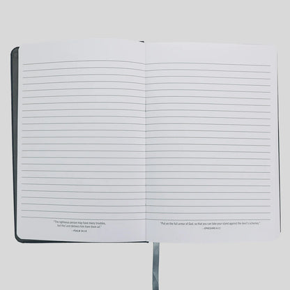An open lined journal or notebook from Kerusso with black text at the bottom of each page, photographed against a light gray background.