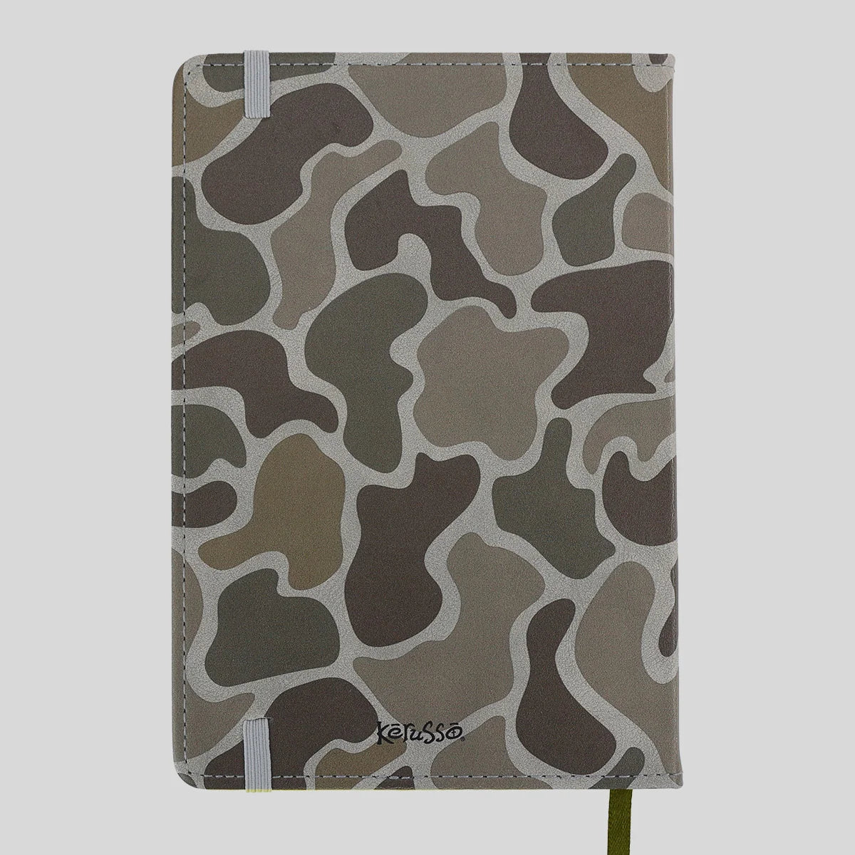 A hardcover notebook from Kerusso with a brown, gray, and beige camouflage pattern cover, featuring white elastic closure bands and a green ribbon bookmark.