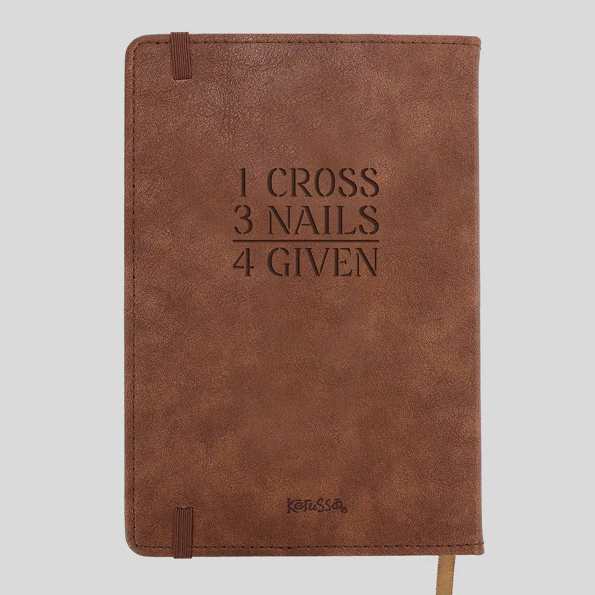 A brown faux-leather notebook with the embossed text '1 CROSS 3 NAILS 4 GIVEN' on the front cover, featuring a matching brown elastic closure tab and a small 'Kerusso' logo near the bottom, shown against a solid light gray background.