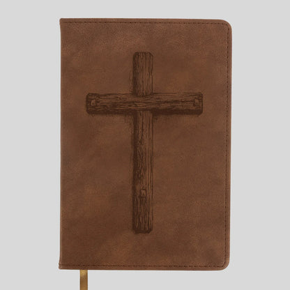 A brown faux-leather Bible or book cover from Kerusso featuring a dark brown embossed wooden cross on the front, shown against a light gray background.