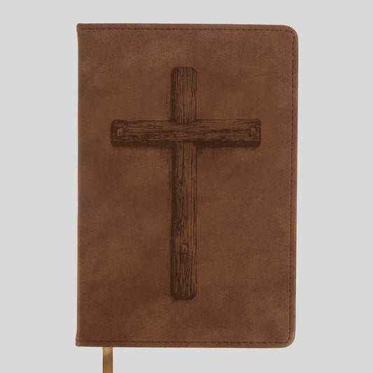 A brown faux-leather Bible or book cover from Kerusso featuring a dark brown embossed wooden cross on the front, shown against a light gray background.