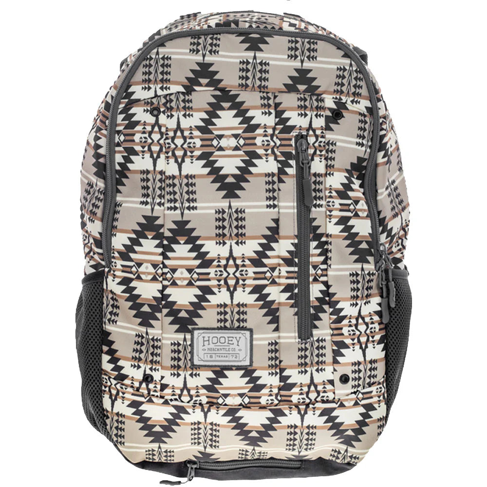 A Hooey backpack featuring a Southwestern geometric pattern in beige, black, and brown, with black mesh side pockets and a front zippered compartment.