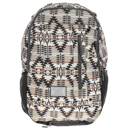 A Hooey backpack featuring a Southwestern geometric pattern in beige, black, and brown, with black mesh side pockets and a front zippered compartment.