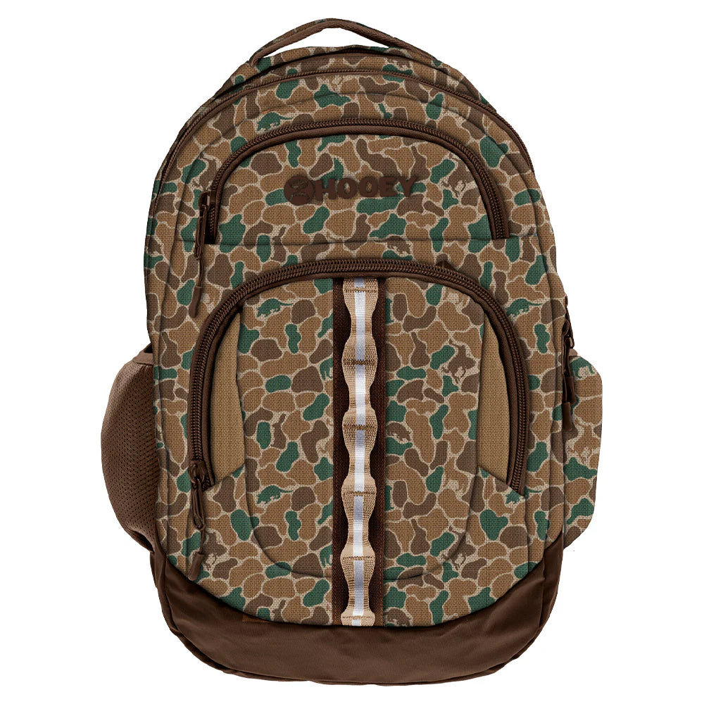 A backpack with a brown and green camouflage pattern and a dark brown Hooey logo on the upper front pocket.