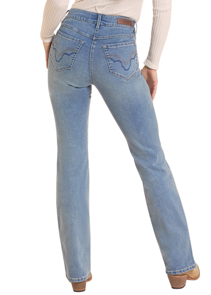 Rear view of a person wearing light blue straight-leg Rock&Roll Denim jeans with decorative stitching on the back pockets, paired with a cream ribbed long-sleeve top and brown shoes, against a white background.