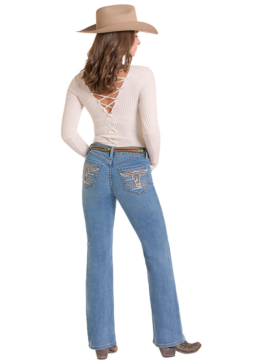 A woman shown from the back wearing a beige wide-brim hat, a cream ribbed long-sleeve top with lace-up back detail, blue jeans with embroidered pocket details, and brown cowboy boots, against a plain white background.