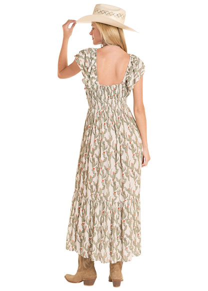 Woman wearing a patterned Rock&Roll Denim dress and straw hat on a white background
