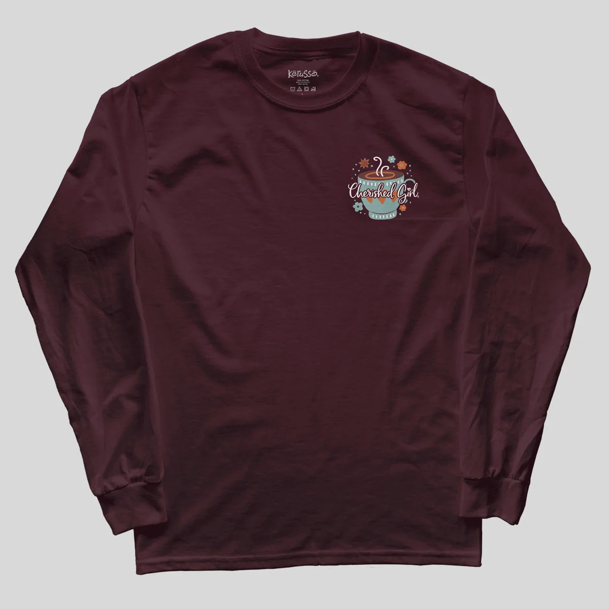A maroon long-sleeve t-shirt with a small graphic on the left chest featuring a teal mug and the text 'Cherished Girl' surrounded by small illustrations, laid flat on a light gray background.