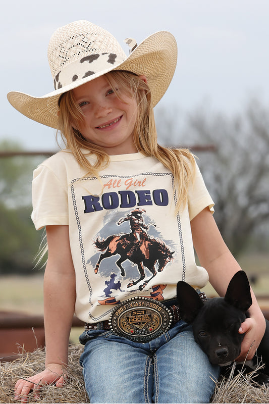 Young girl wearing a 'All Girl Rodeo' cruel girl t-shirt with a cowboy graphic, holding a black dog, and wearing a cowboy hat.