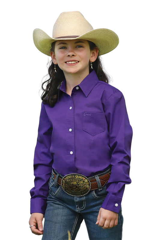 girl wearing purple Cruel Girl Cinch shirt, jeans and a cowboy hat on white background