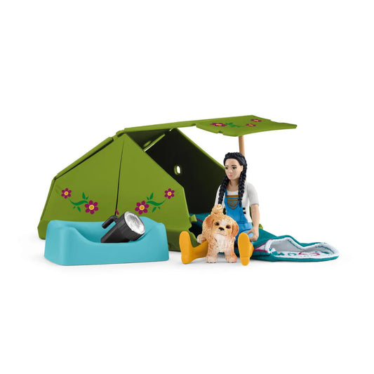 Schleich toy doll with a dog and camping gear including a tent on a white background