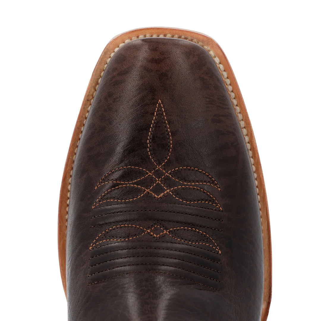 Close-up of a brown leather boot with intricate stitching on a white background