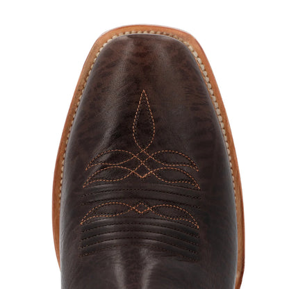 Close-up of a brown leather boot with intricate stitching on a white background