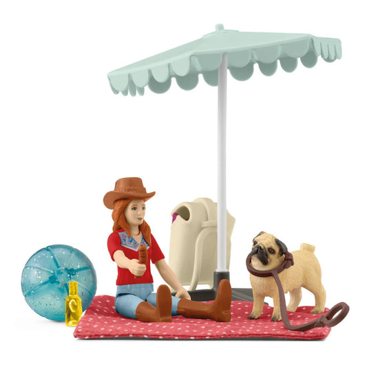Schleich toy figure of a girl with a dog under an umbrella on a white background