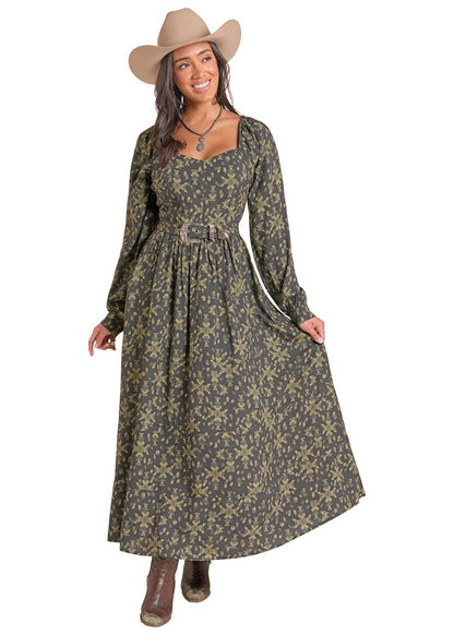 Woman wearing a green and black long dress by Panhandle Slim and a brown cowboy hat on a white background