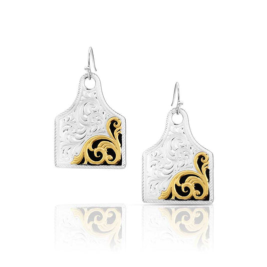 Pair of Montana Silversmiths earrings with gold and black designs on a white background