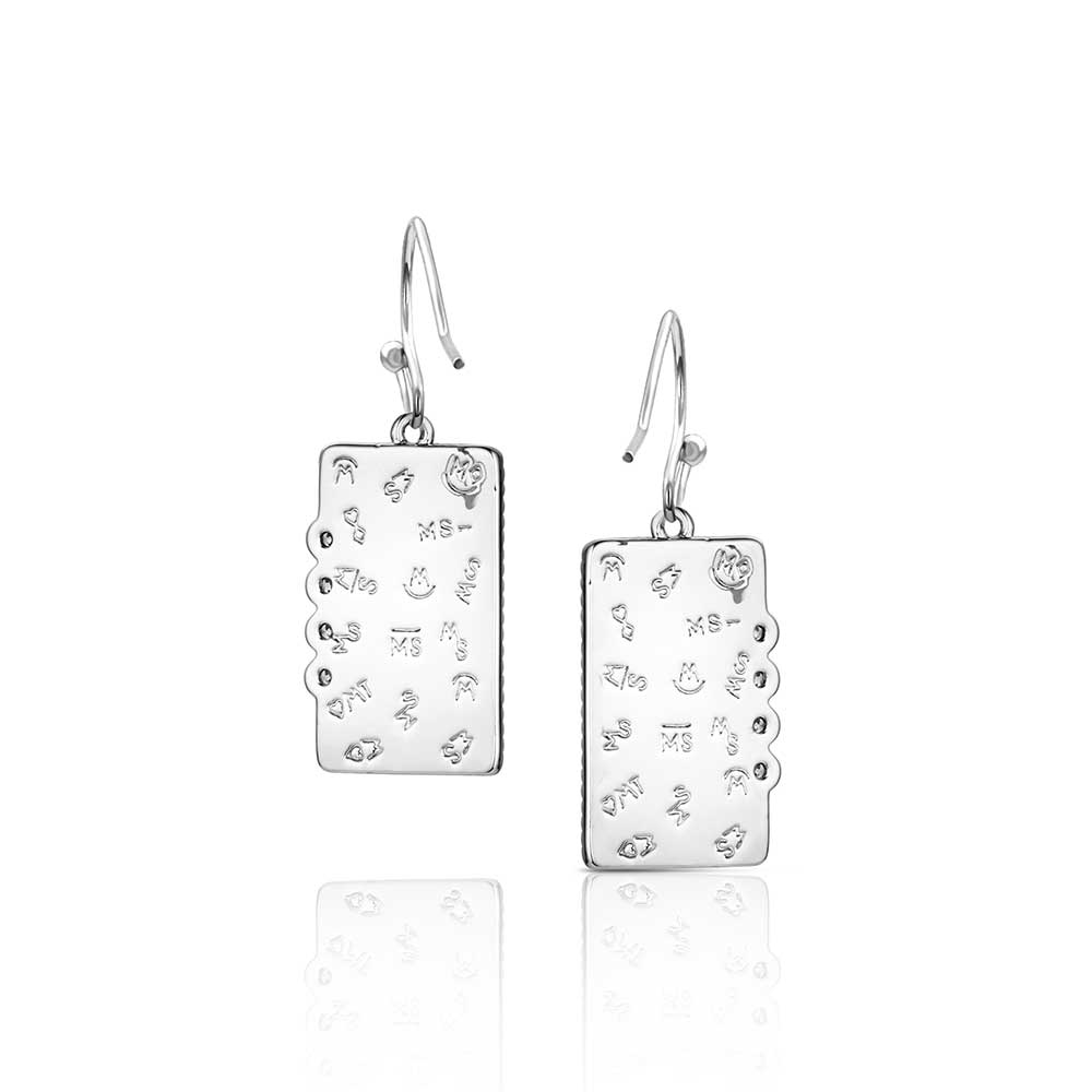 Pair of Montana Silversmiths silver earrings with intricate designs on a white background