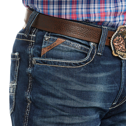 denim Ariat jeans with a brown belt on a white background