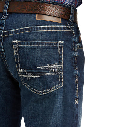 demin Ariat jeans with a brown belt on a white background