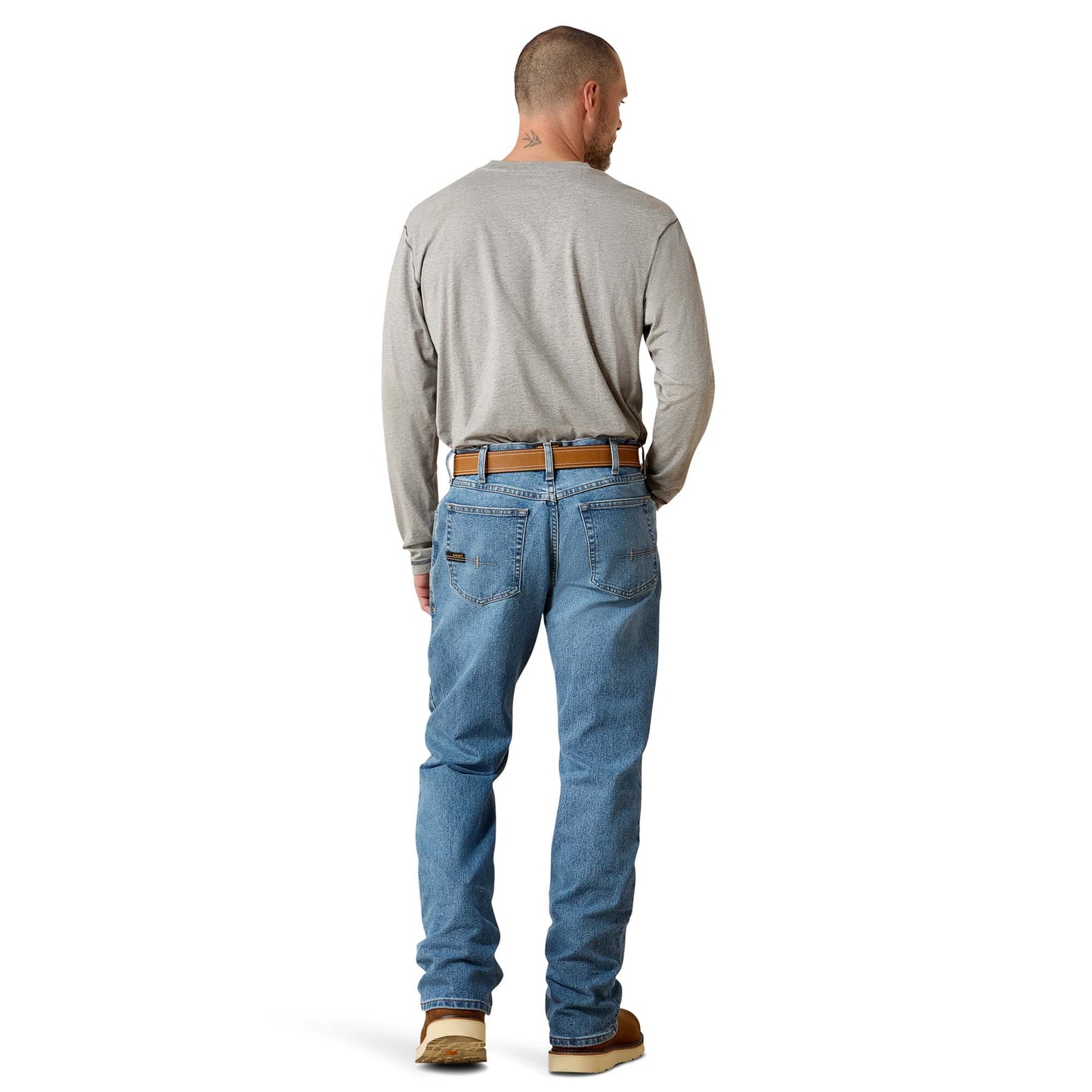 Man wearing Ariat jeans and grey shirt on a white background