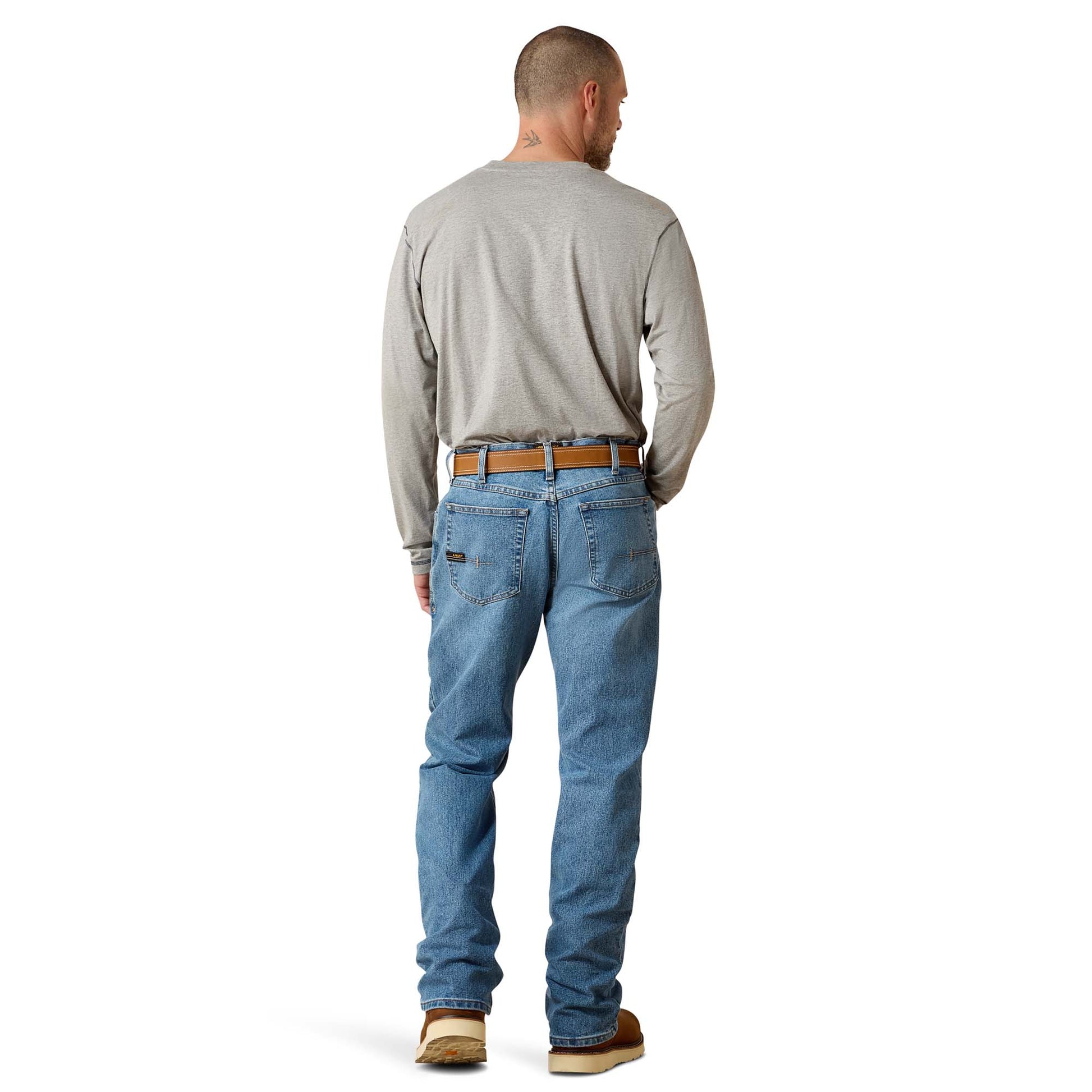 Man wearing Ariat jeans and grey shirt on a white background